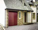 Seceuroglide Excel insulated aluminium roller shutter garage door with a long lasting burgundy powder coated paint finish.