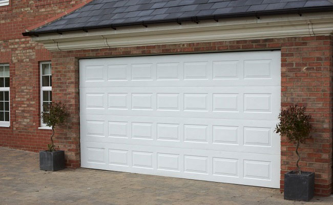 Gliderol Georgian Sectional Garage Door painted white and fitted to large detached house