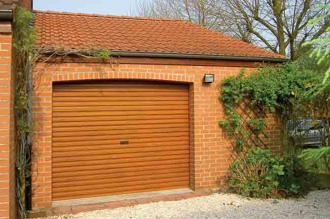 Gliderol single skin steel roller door with a golden oak woodgrain finish.