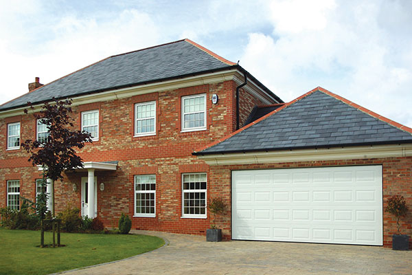 Gliderol Georgian sectional garage door with an electric operator fitted to a large detached garage.