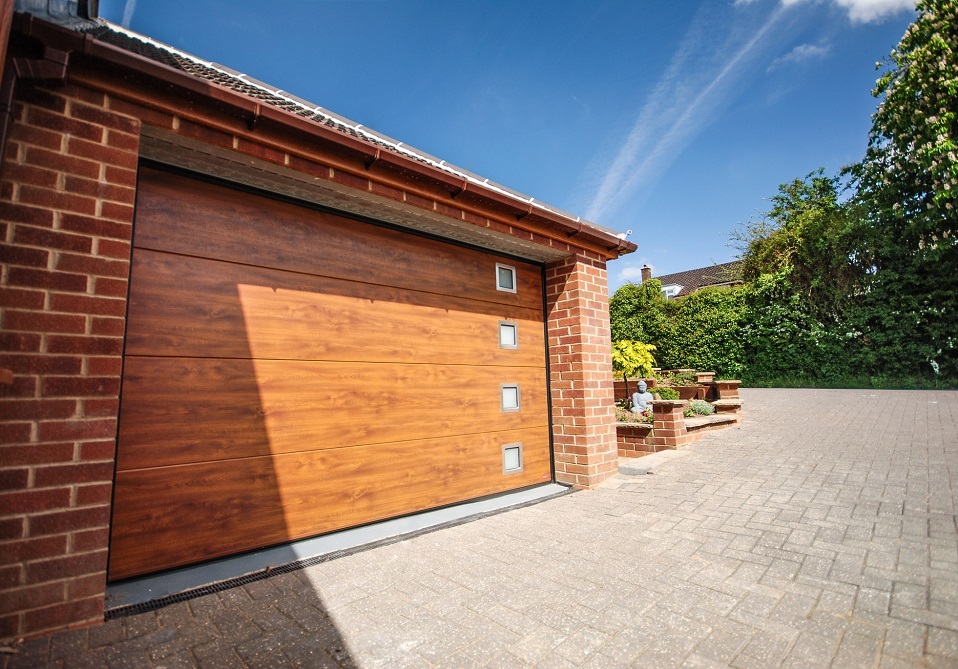Birkdale Sectional Garage Door with a golden oak woodgrain finish combined with square windows