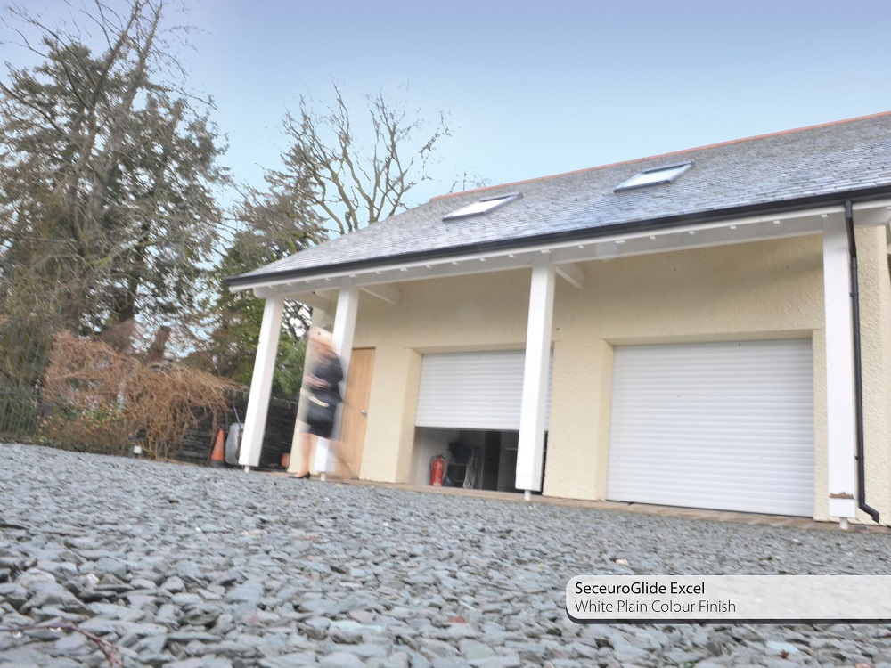 SeceuroGlide Excel roller garage door finished in plain white to complement a white rendered detached house