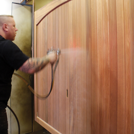 Staining a Woodrite wooden garage door during manufacture