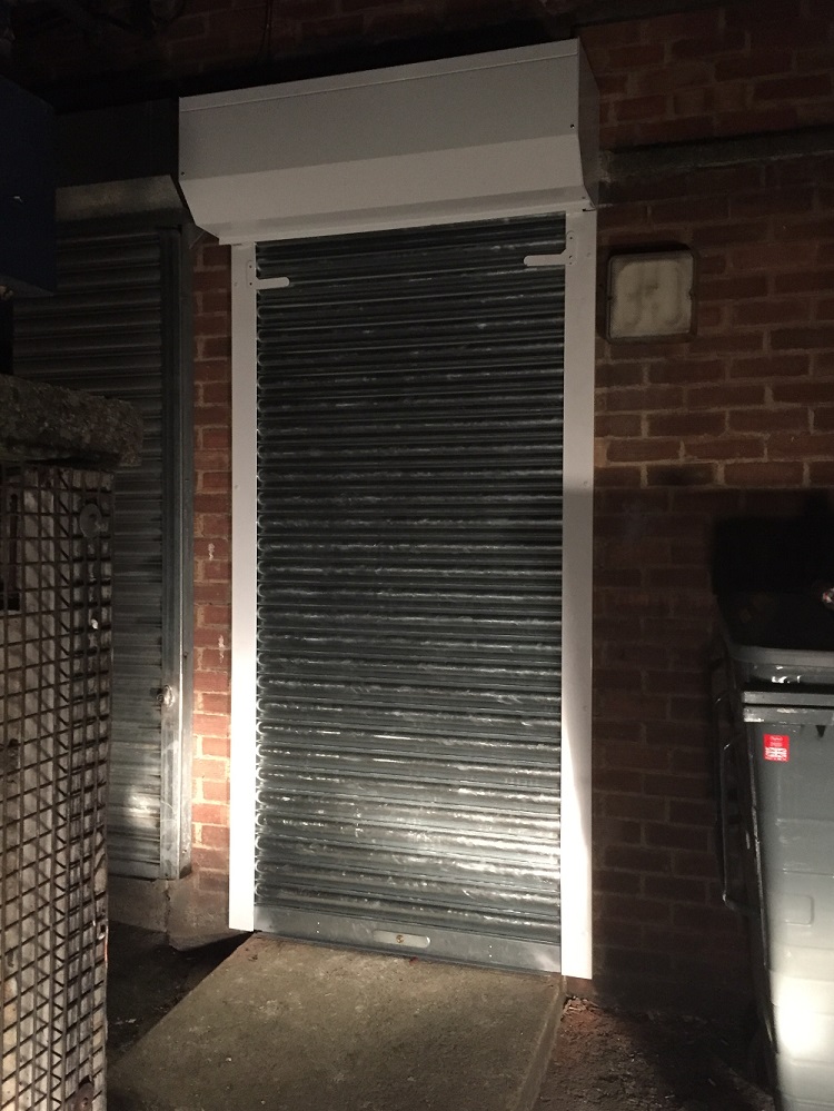 Seceuroshield 75 galvanised roller shutter door fitted to rear access point of a charity shop in Leeds, Yorkshire.