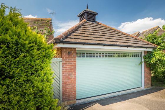 Seceuroglide automatic roller garage door with a chartwell green paint finish