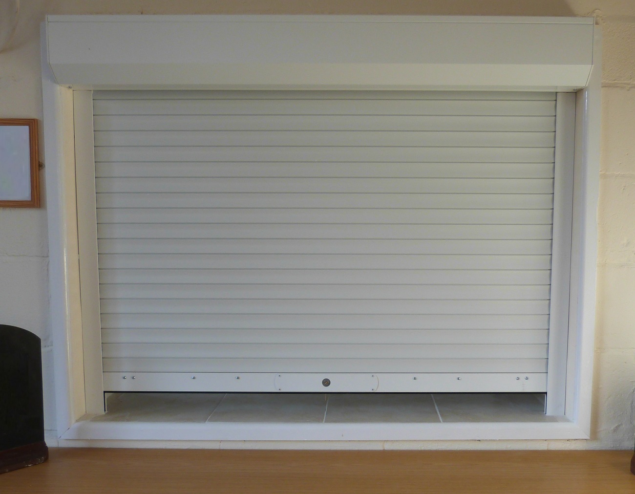 Seceuroshield 38 extruded aluminium roller shutter installed within a kitchen serving hatch in village hall located in Surrey.