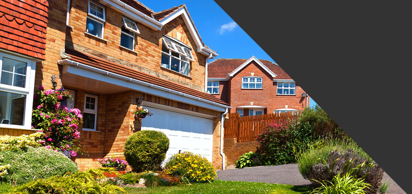 white garage doors fitted to modern home